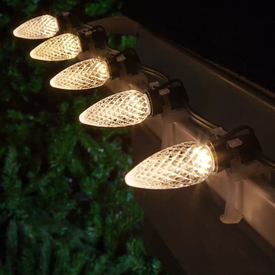 Faceted C9 LED bulbs illuminated on roofline - diamond-cut brilliance